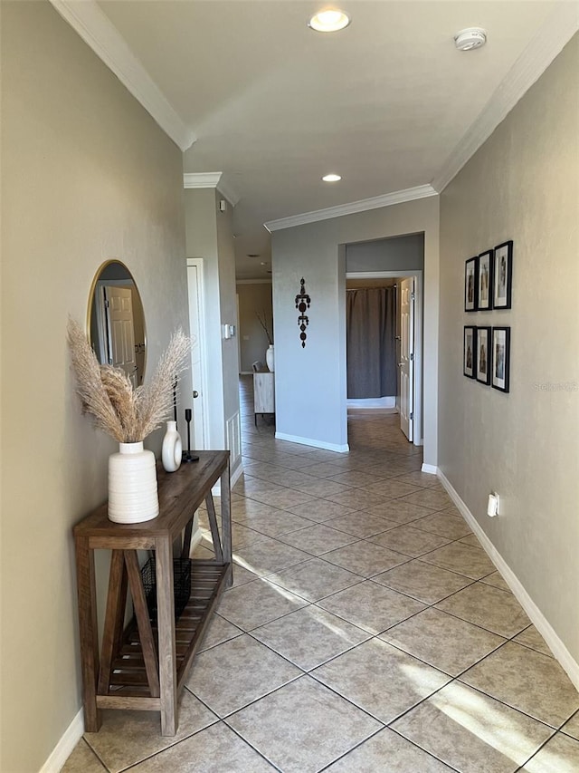 hall featuring light tile patterned flooring and ornamental molding