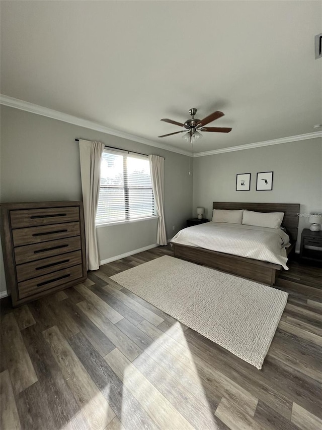 bedroom with ceiling fan, dark wood-type flooring, and ornamental molding