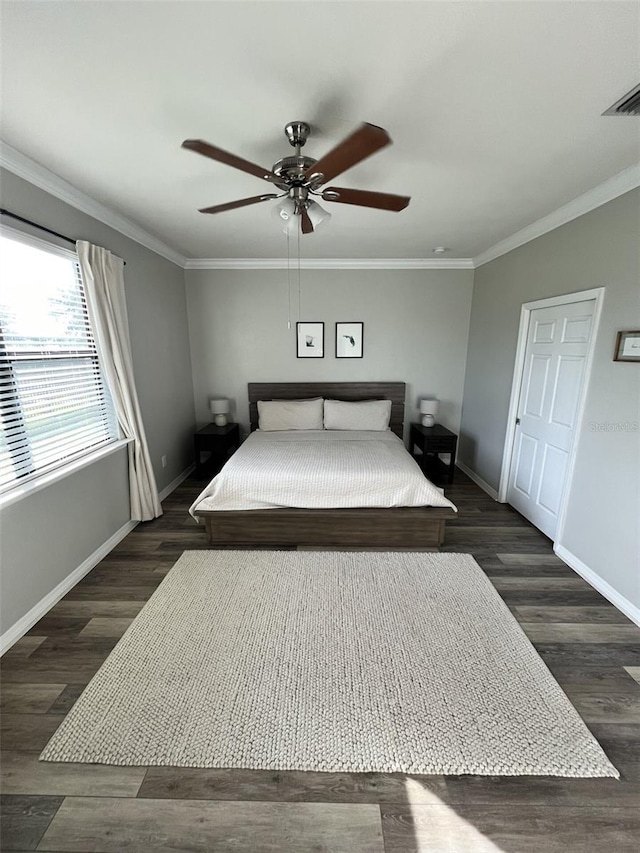 unfurnished bedroom with ceiling fan, ornamental molding, and dark wood-type flooring