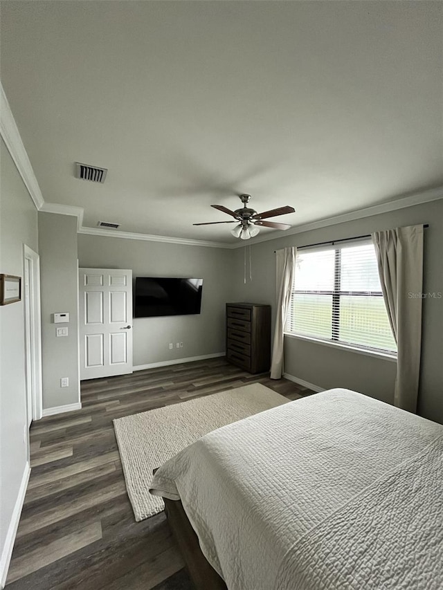 bedroom with crown molding, ceiling fan, and dark wood-type flooring