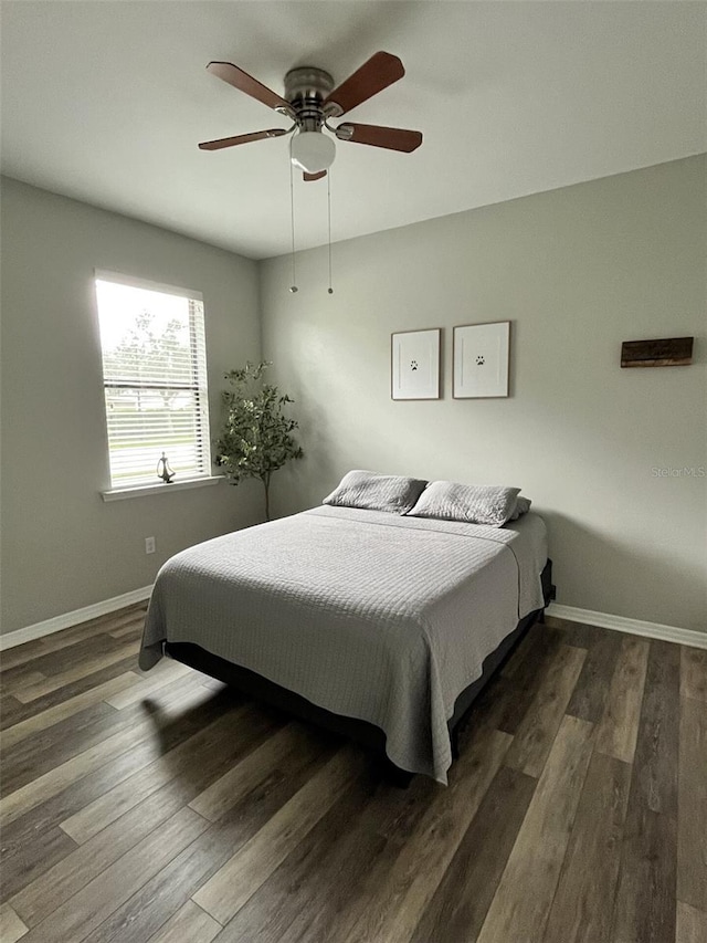 bedroom featuring ceiling fan and dark hardwood / wood-style flooring