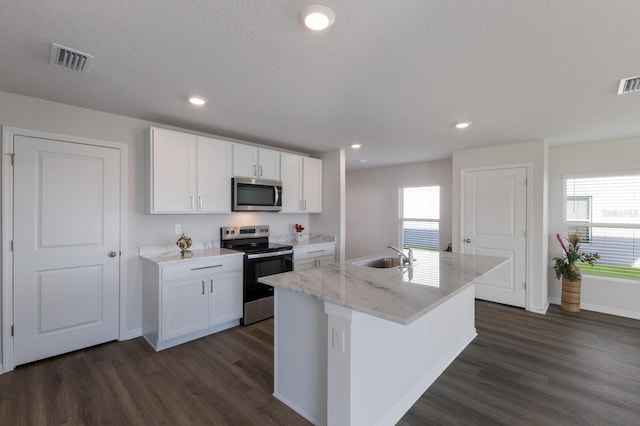 kitchen featuring stainless steel appliances, a kitchen island with sink, sink, dark hardwood / wood-style floors, and white cabinetry