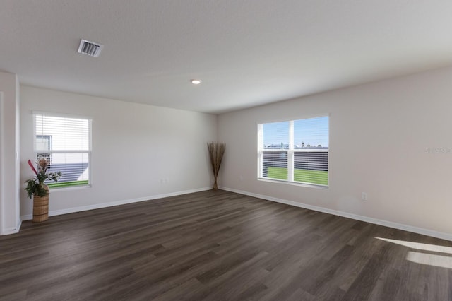 unfurnished room featuring dark hardwood / wood-style floors