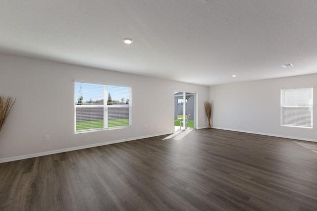 spare room featuring dark hardwood / wood-style floors