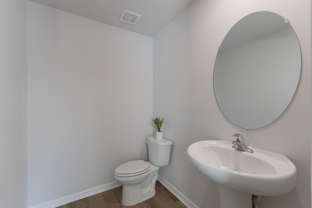 bathroom featuring hardwood / wood-style floors, toilet, and sink