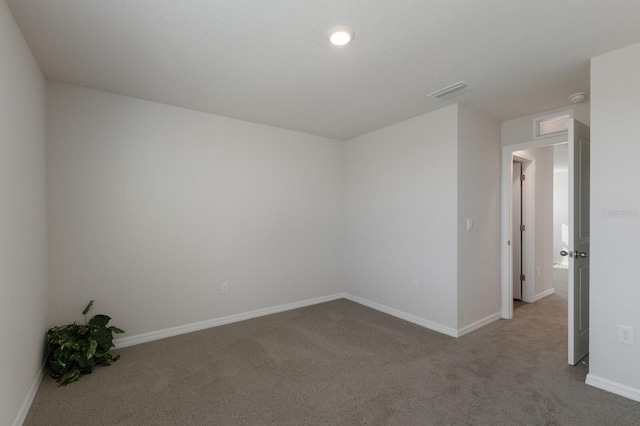 unfurnished room featuring light colored carpet