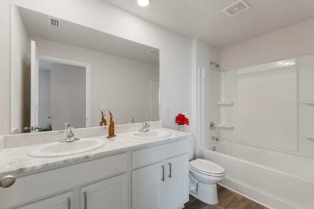 full bathroom with vanity, toilet, wood-type flooring, and bathtub / shower combination