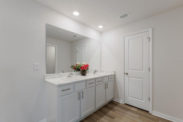 bathroom featuring hardwood / wood-style flooring and vanity