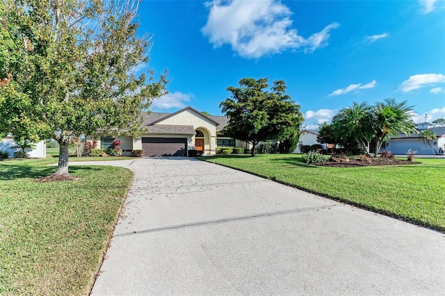 view of front facade with a front yard and a garage