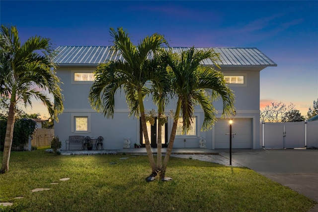 view of front of house featuring a lawn and a garage