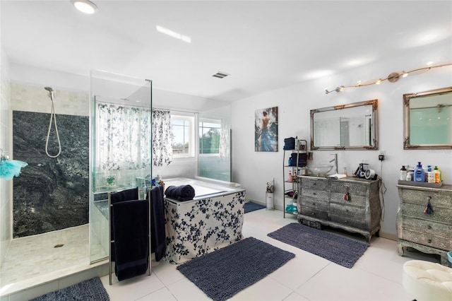 bathroom with tile patterned floors, vanity, and shower with separate bathtub