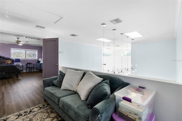 living room with wood-type flooring, ceiling fan, and crown molding