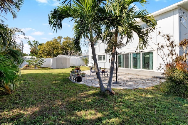 view of yard with a patio and a shed