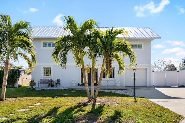 view of front of property with a front yard and a garage