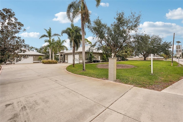 ranch-style home featuring a garage and a front lawn