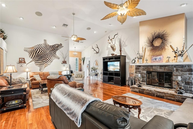 living room with vaulted ceiling, light hardwood / wood-style flooring, and a fireplace