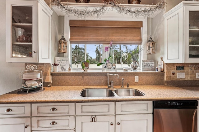 kitchen featuring sink, white cabinets, and dishwasher