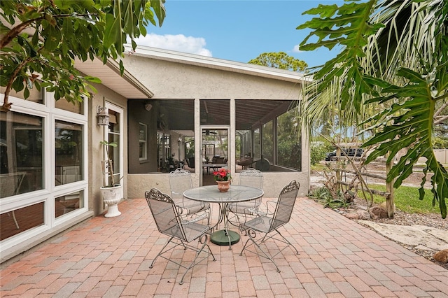 view of patio featuring a sunroom