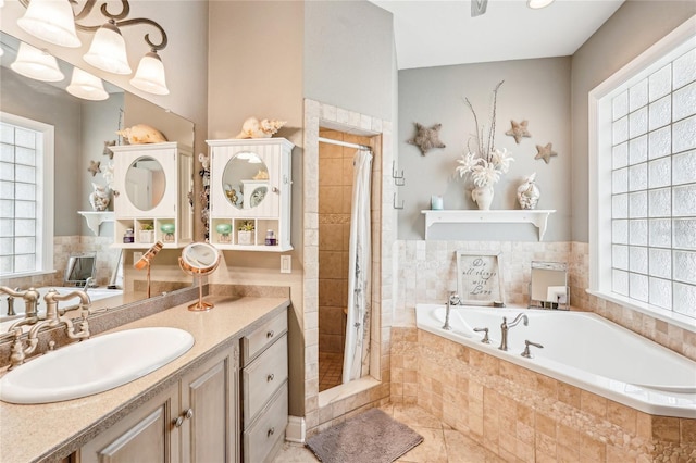 bathroom with vanity, tile patterned flooring, and independent shower and bath