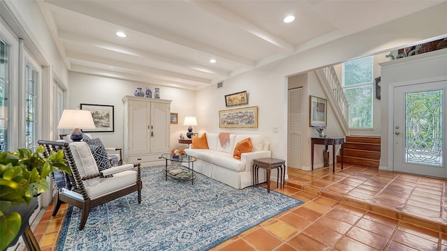 tiled living room featuring beam ceiling