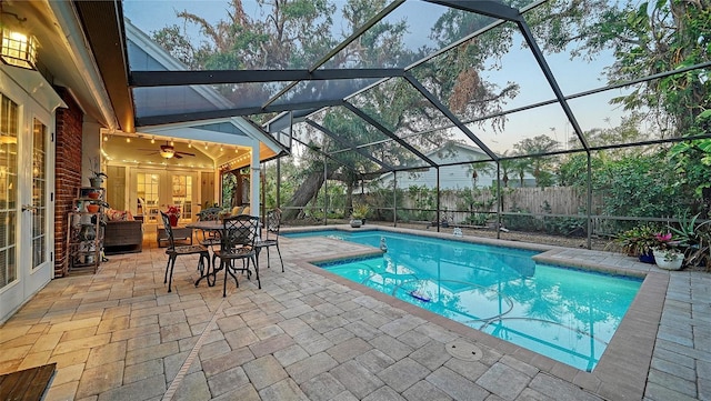 view of pool with a patio, ceiling fan, and a lanai