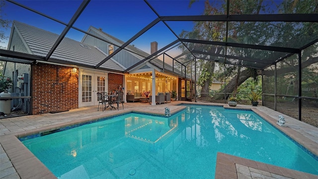 view of pool featuring french doors, an outdoor hangout area, a patio, and a lanai