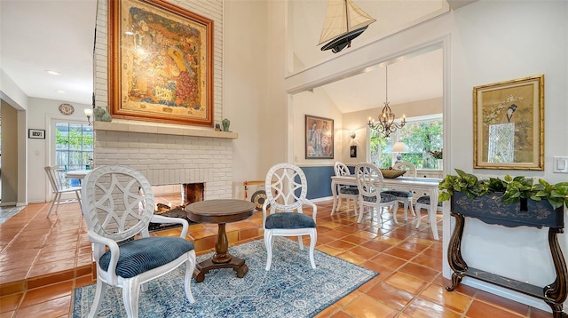 sitting room with a brick fireplace, tile patterned floors, and plenty of natural light