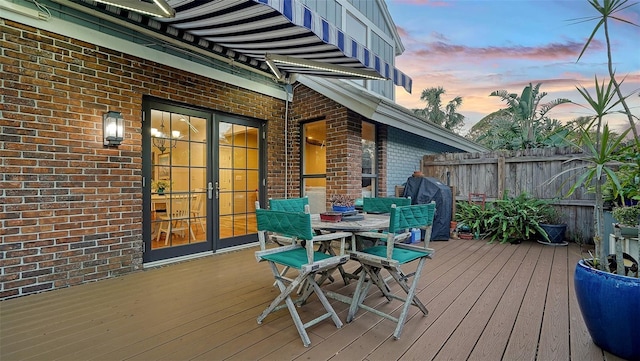 deck at dusk with grilling area