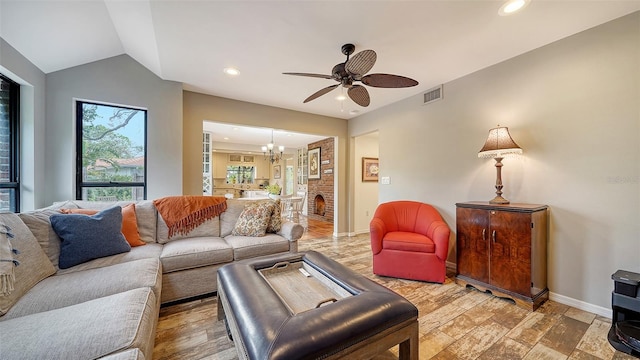 living room featuring hardwood / wood-style floors, ceiling fan with notable chandelier, and lofted ceiling