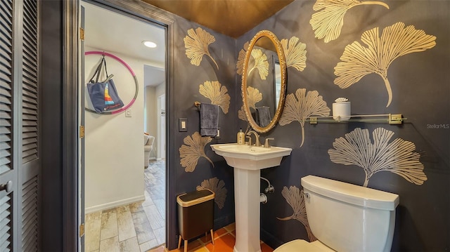 bathroom featuring hardwood / wood-style floors and toilet