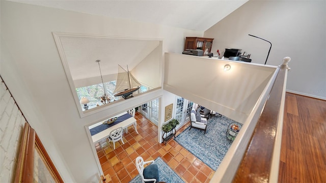 living room with tile patterned flooring and high vaulted ceiling