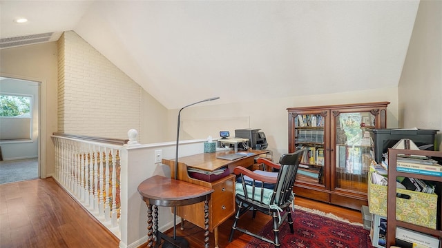 office space featuring hardwood / wood-style flooring and vaulted ceiling