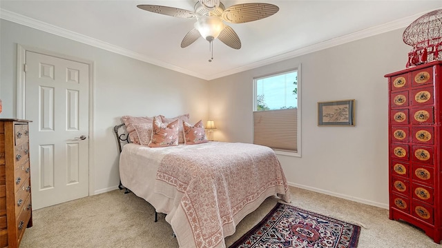 carpeted bedroom with ceiling fan and ornamental molding