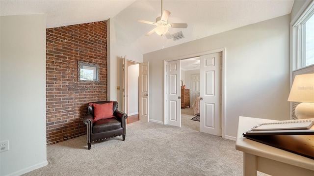 living area with ceiling fan, light colored carpet, and vaulted ceiling