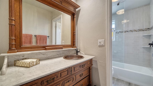 full bathroom featuring hardwood / wood-style flooring, vanity, toilet, and tiled shower / bath combo