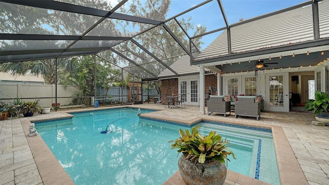 view of swimming pool with glass enclosure, french doors, an outdoor hangout area, ceiling fan, and a patio area