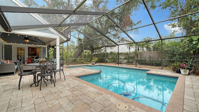 view of swimming pool featuring a patio, ceiling fan, and a lanai