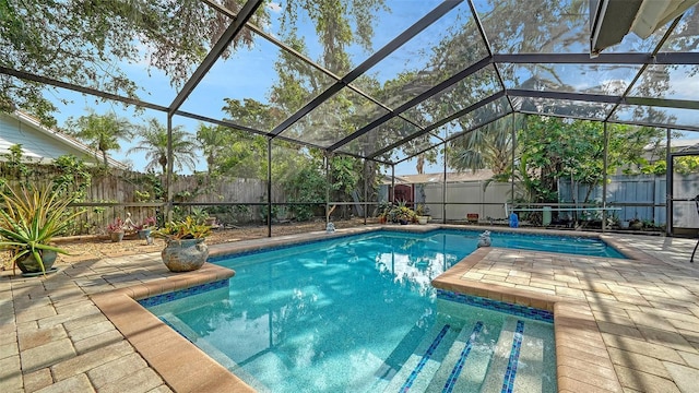 view of swimming pool featuring a lanai and a patio area