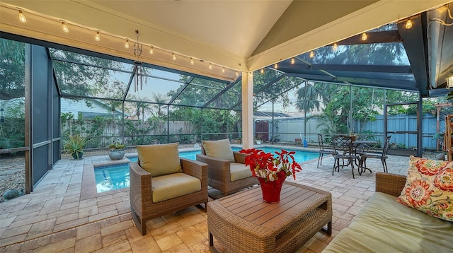 view of patio / terrace with outdoor lounge area, a fenced in pool, and glass enclosure