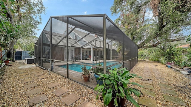 view of pool with glass enclosure and a patio area