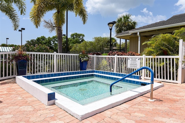 view of swimming pool with a community hot tub