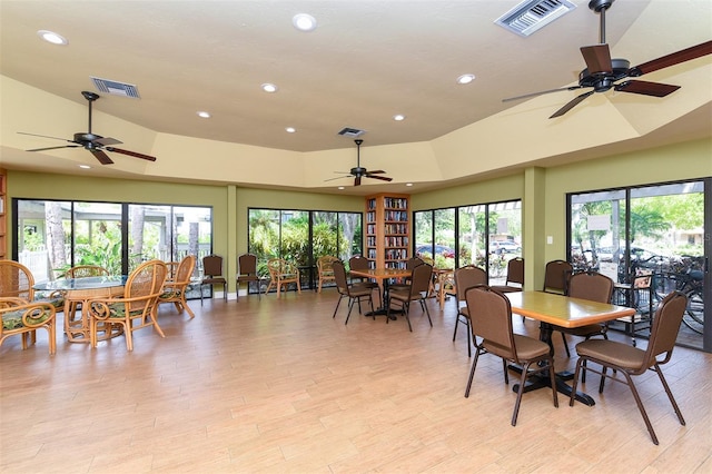 dining area featuring ceiling fan, light wood-type flooring, and high vaulted ceiling