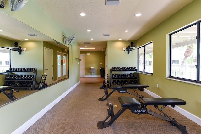 exercise area featuring a textured ceiling