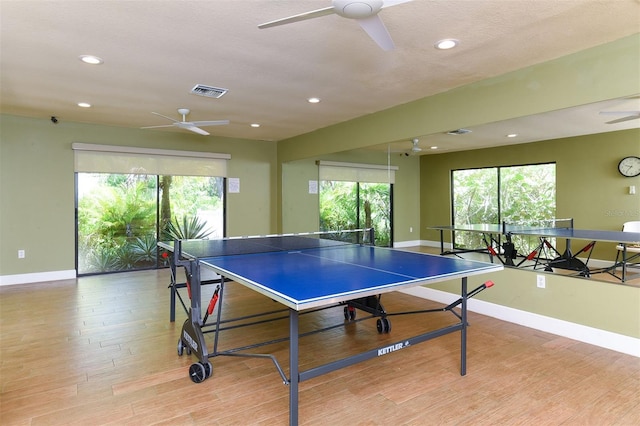 recreation room featuring light hardwood / wood-style flooring and ceiling fan