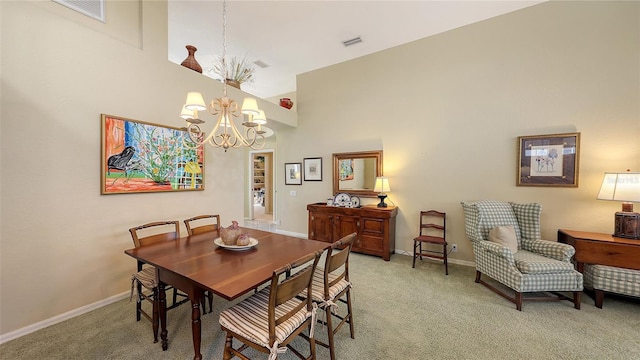 dining space featuring carpet floors, a towering ceiling, and a chandelier