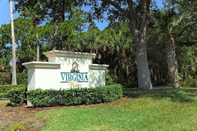 community sign featuring a lawn