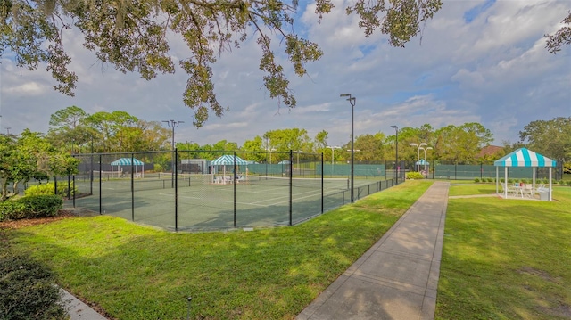 view of sport court with a yard