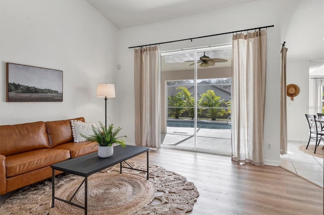 living room featuring light hardwood / wood-style floors and ceiling fan