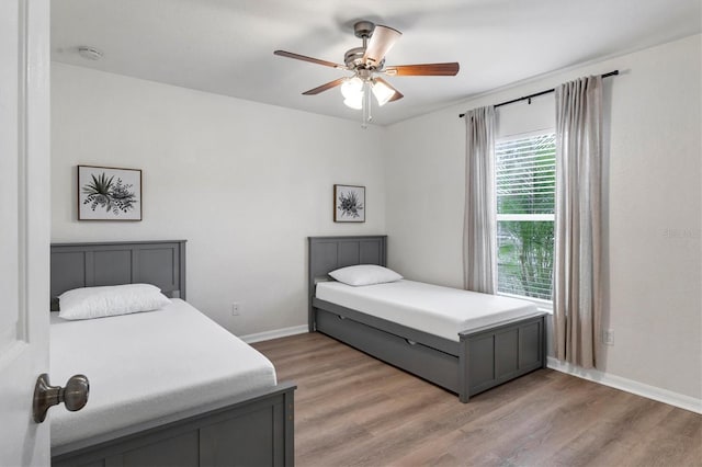 bedroom with ceiling fan and light hardwood / wood-style floors