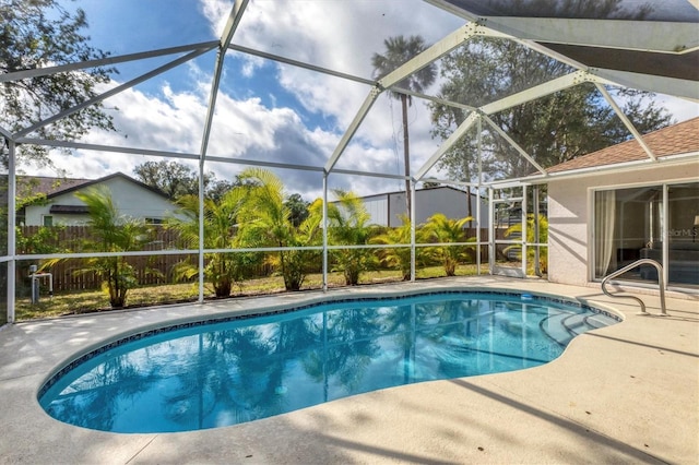 view of swimming pool featuring a patio area and glass enclosure